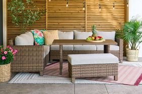 BHG patio set on exterior patio with decorative pillows, plants, and lighting