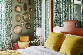 Green bedroom with a canopy bed and brass accents