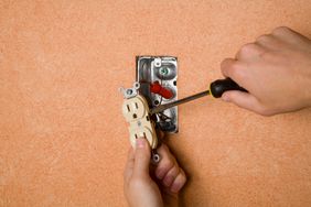 Flathead screwdriver installing an outlet