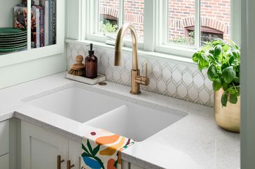 white kitchen sink with gold faucet