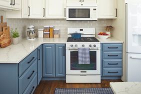 blue cabinets in a kitchen with a white oven and microwave