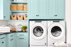 Light blue laundry room with a washer and dryer