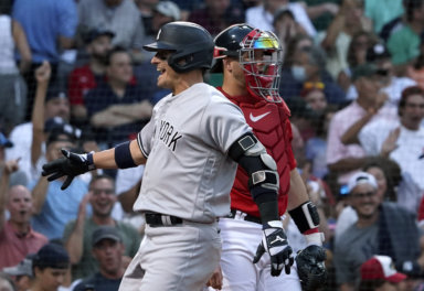 Yankees' Josh Donaldson celebrates in front of Boston Red Sox catcher Kevin Plawecki after hitting a grand slam.