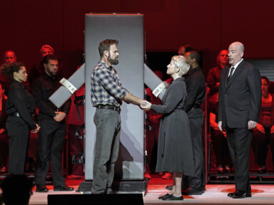 This image released by the Metropolitan Opera shows Ryan McKinny as Joseph De Rocher, foreground left, Joyce DiDonato as Sister Helen Prejean, foreground center, and Raymond Aceto as George Benton in Jake Heggie's "Dead Man Walking" on Sept. 15, in New York.