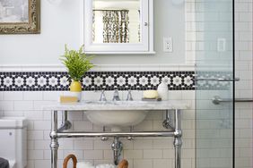 large woven basket holding folded towels under bathroom sink