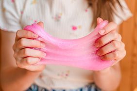 child pulling pink slime