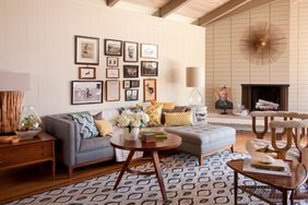 gallery with antique portraits over couch in living room