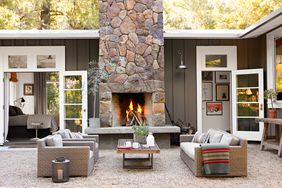 outdoor fireplace on gravel patio
