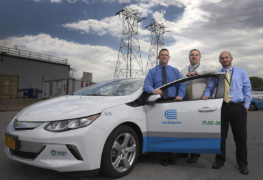 William Tesi, Fortunate Gufino and Joseph Venezia, from transportation, stand by the new Chevy Volt Electric Hybrid in Astoria, which will become part of the Con Edison fleet