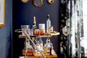 Dark blue wall next to bar cart