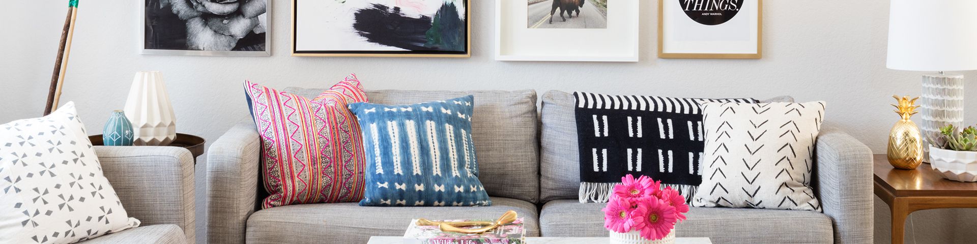 Grey sofa with several colorful pillows