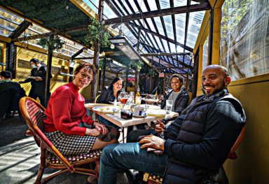 Restaurant patrons eat at an outdoor dining shed in New York.
