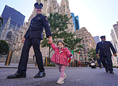Columbus Day Parade marchers: A police officer with little girl