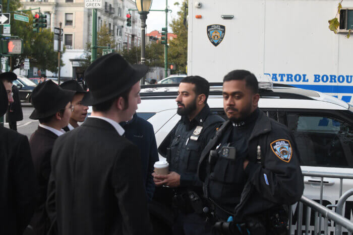 NYPD officers patrol outside a Brooklyn synagogue on Friday.