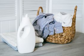 liquid detergent with clothes in laundry basket