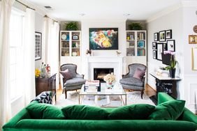 living room with dark green sofa and fireplace