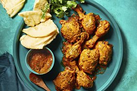 butter chicken on teal platter