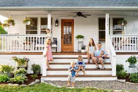 Parents with kids on entrance steps of house