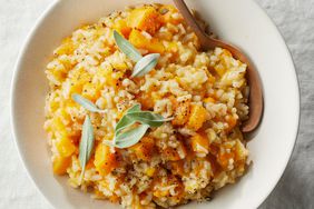 bowl of butternut squash risotto topped with fresh sage leaves