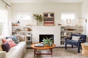 renovated neutral-colored living room with pink and blue accent pieces